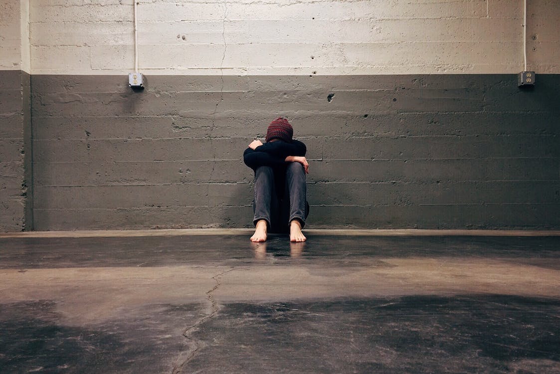 A person dealing with anxiety is sitting alone