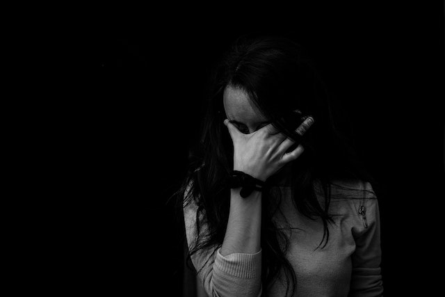 A girl covering her face with her hand
