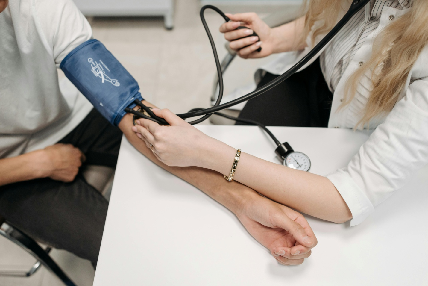 A person getting their blood pressure checked by a healthcare worker
