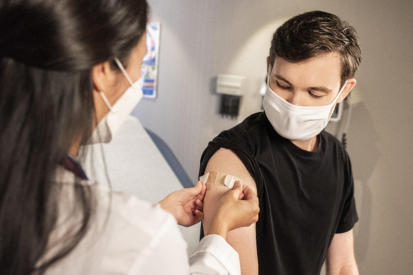  A doctor wearing a lab coat mid-conversation with her patient