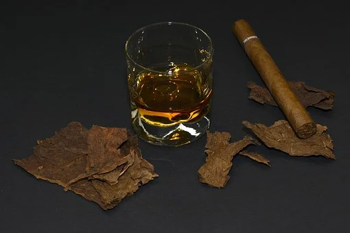 Glass of wine and cigar on a surface