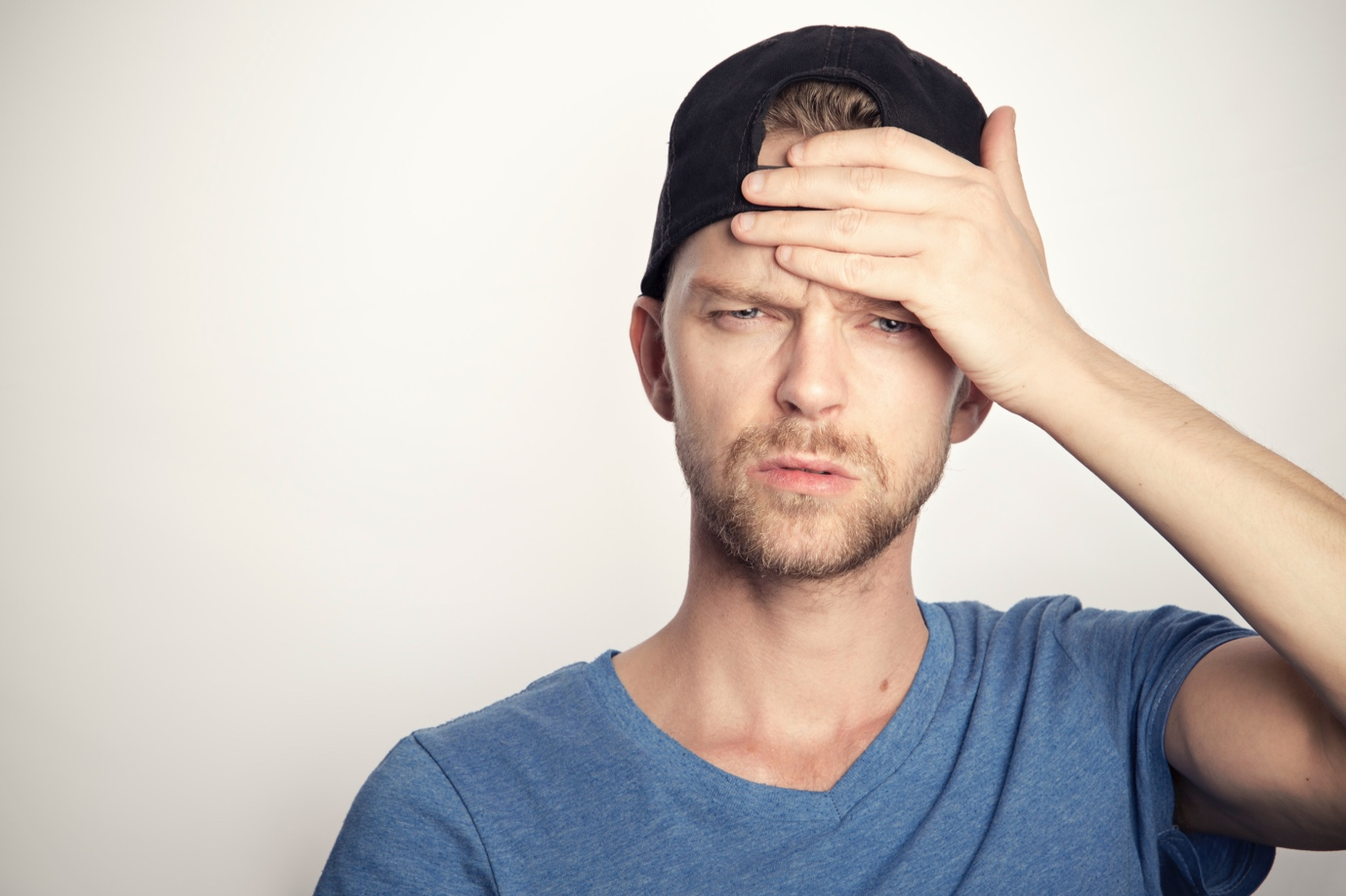 A person having a headache holding their head