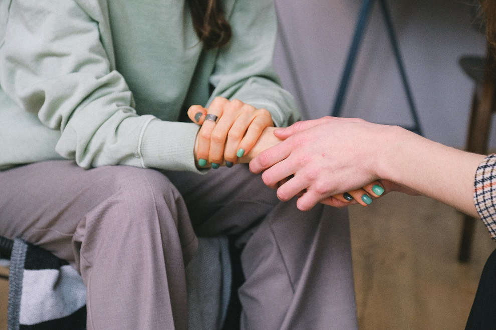 Cropped people holding hands