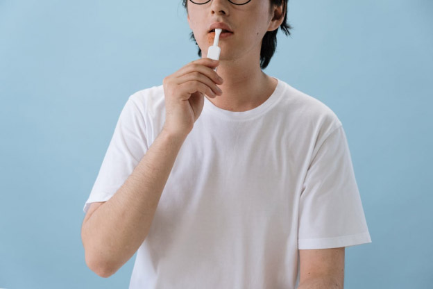 A person using mouth ointment