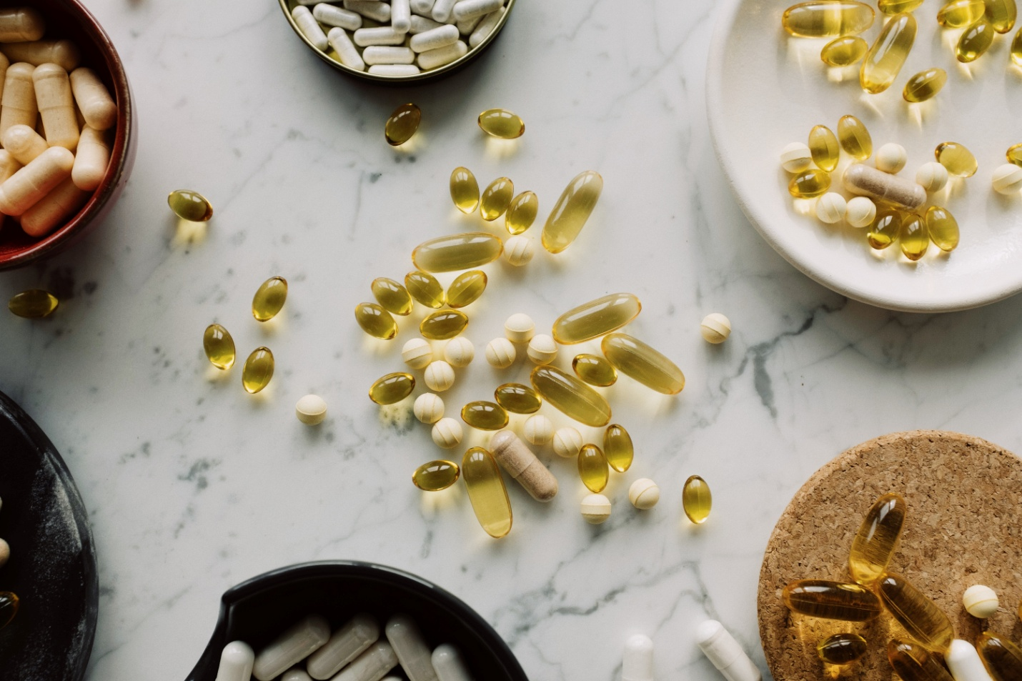 Pills kept in plates and other containers on a counter top