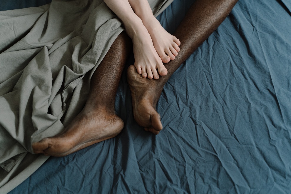 A couple’s legs tangled in sheets