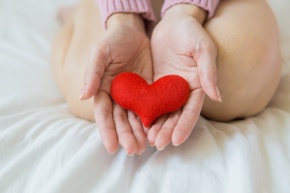  Woman holding a heart in her hand