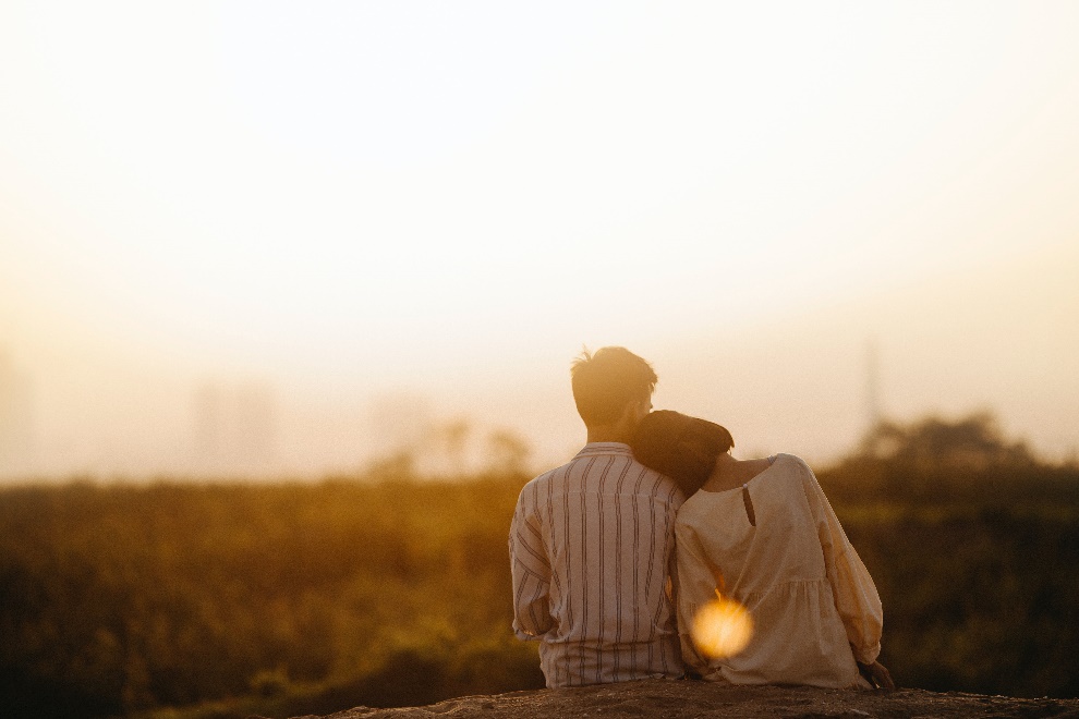 Woman resting her head on man’s shoulder