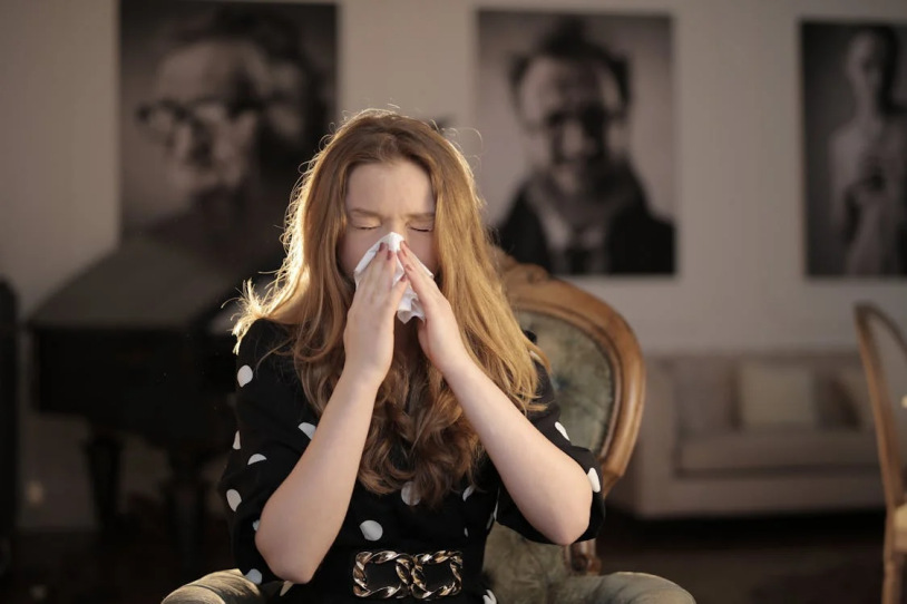 A photo of a woman wiping her nose