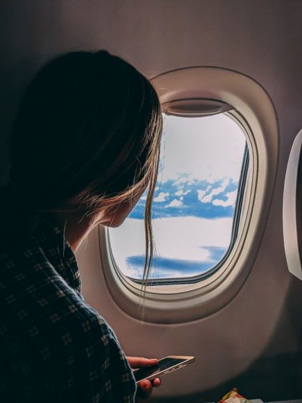 a-girl-looking-out-an-airplane-window