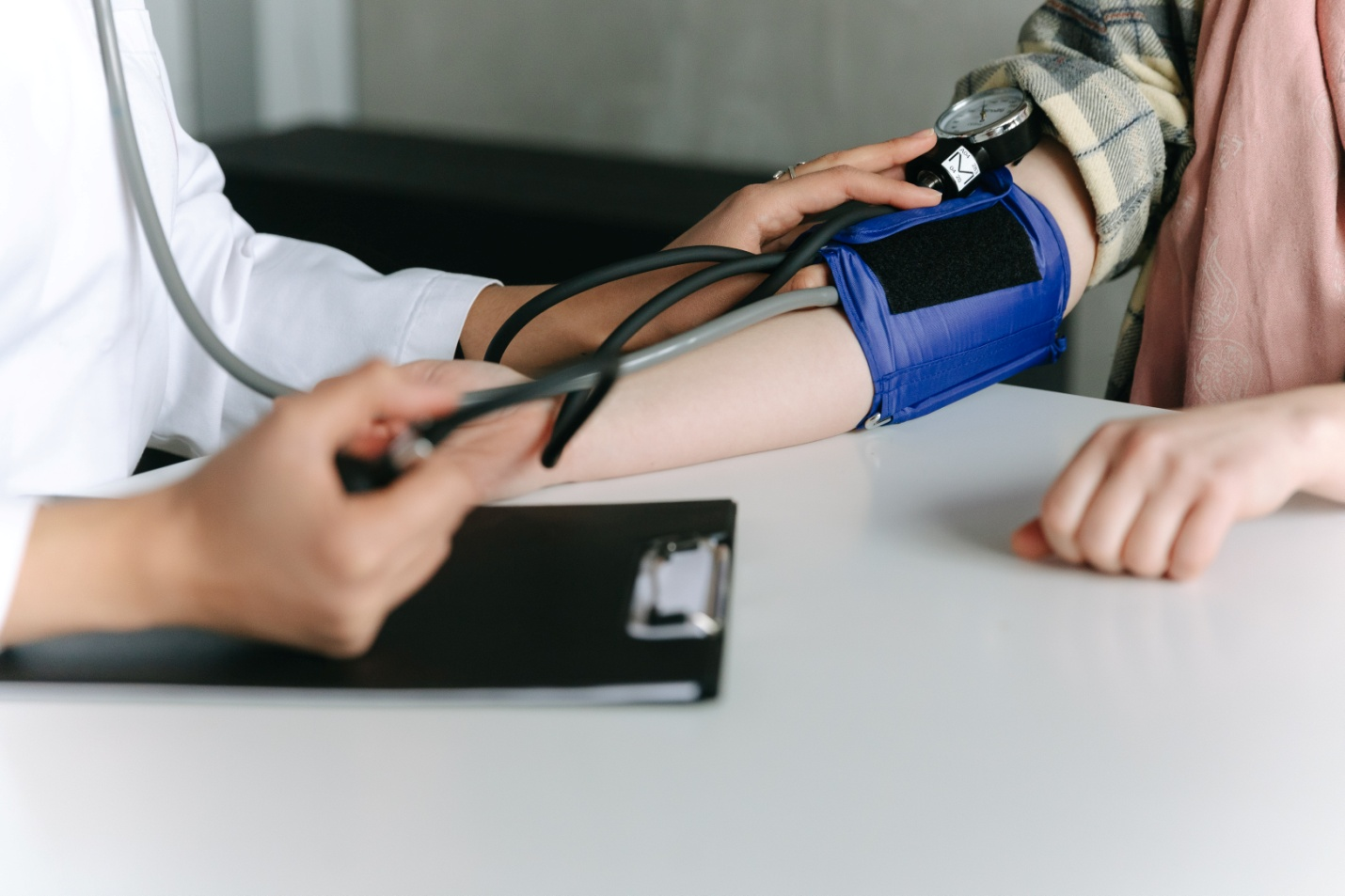 A healthcare professional measuring a patient's blood pressure