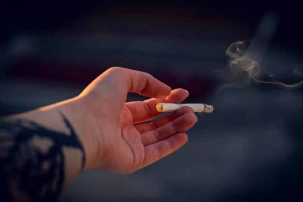 a cigarette in a hand
