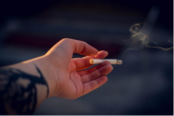 Hand holding a cigarette