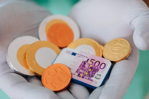 Close up of doctor holding money 
