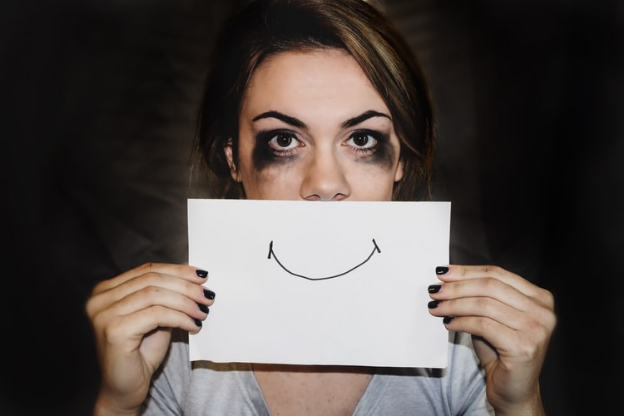 A girl projecting happy when she's depressed inside
