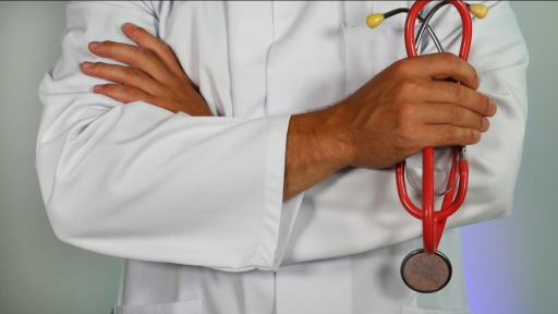 a male doctor holding a stethoscope