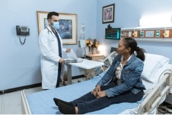 Doctor consulting a patient in a hospital room