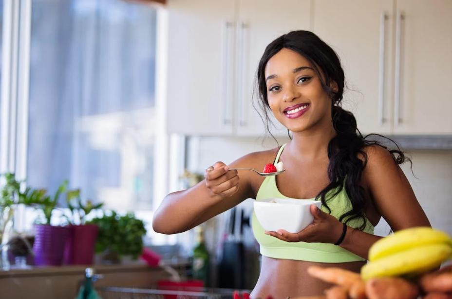 Woman eating a cut-up fruit. 