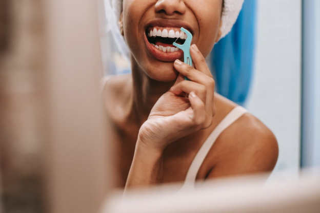 a person flossing her teeth