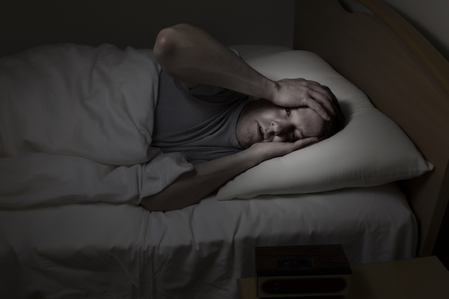 Man having trouble sleeping.