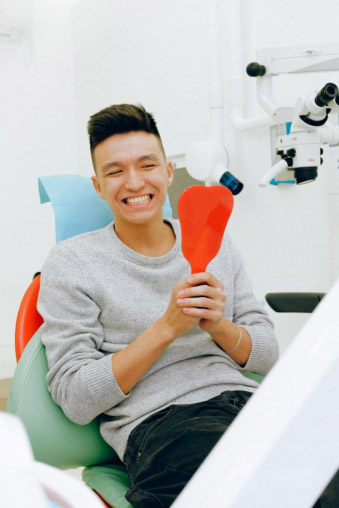man inspecting his teeth