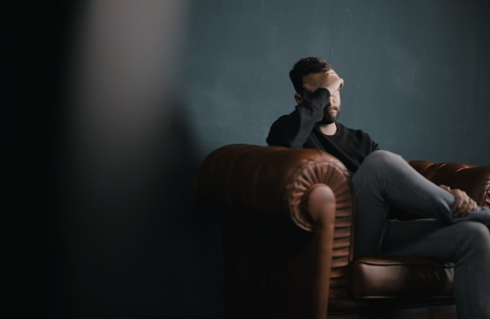 An image of a man sitting on a sofa