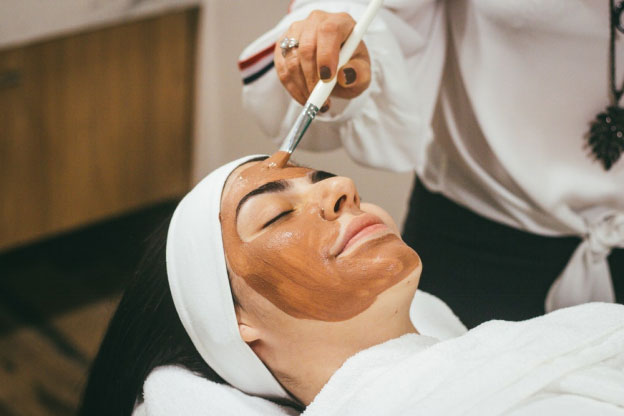 a woman applying face mask