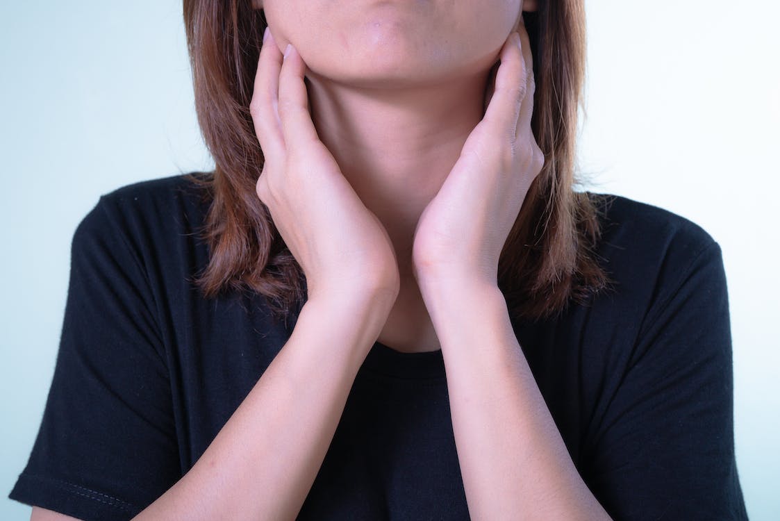 A woman touching her neck