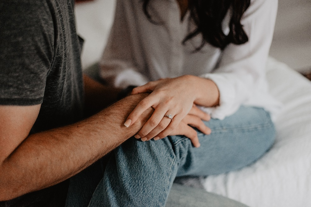 a woman holding man’s hand