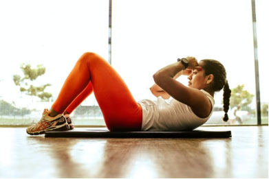 a woman exercising while lying on the ground