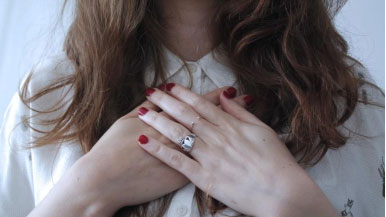 A woman with her hands on her heart
