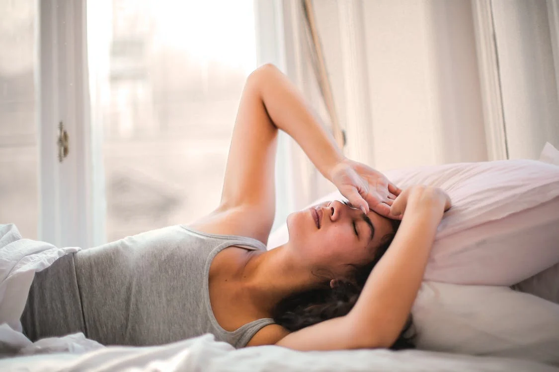 A woman lying down in bed