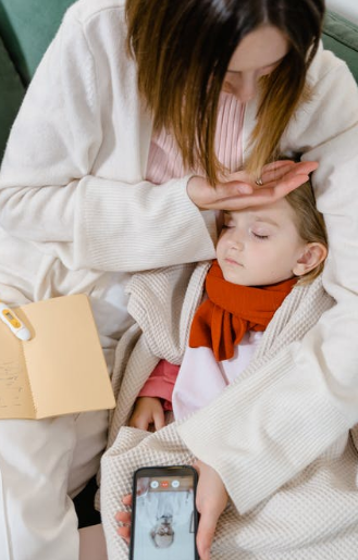 A mother checks for allergy symptoms in her baby while consulting an online doctor