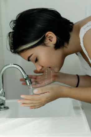 Woman washing her face